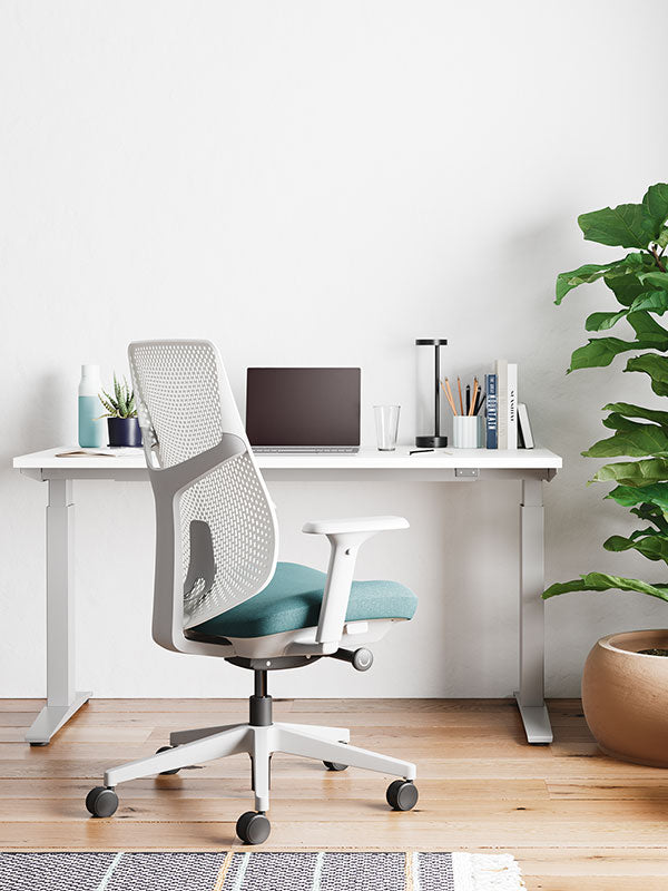 Verus  home office chair in white and pale blue in front of white Nevi sit-stand  desk 