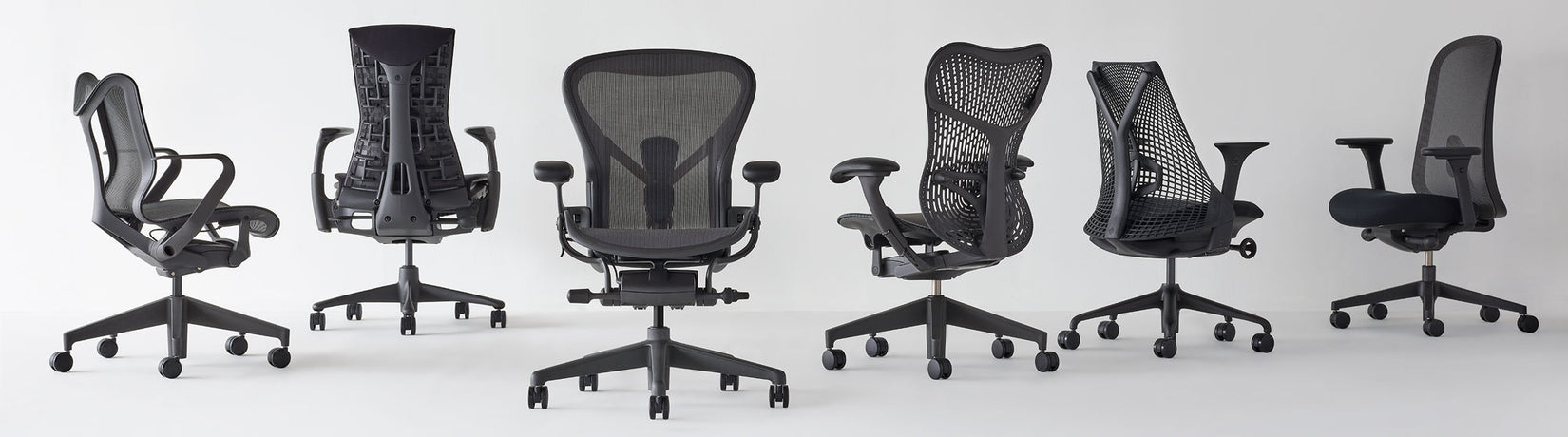 Line up of Herman miller home office chairs at different angles all in graphite featuring Cosm low back, Aeron , Mirra 2 and Lino
