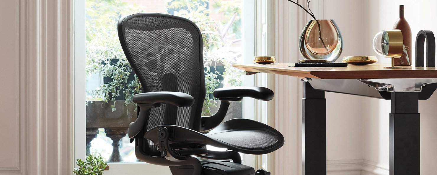 Close up view of a Graphite Aeron swivelled at a 45 degree angle in a home working setting