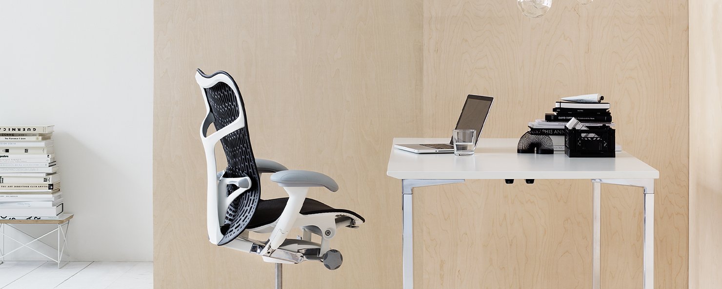 A grey and white Mirra 2 chair in a home office environment.